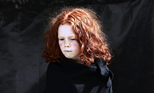 Maggie Noonan, 7, poses for a portrait during the Irish Redhead Convention in the village of Crosshaven in County Cork