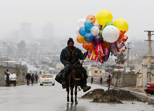 An Afghan man rides on his donkey during Newroz Day celebrations in Kabul