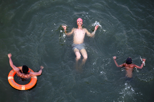 People swim in river Yamuna to cool off during a hot summer day in Allahabad