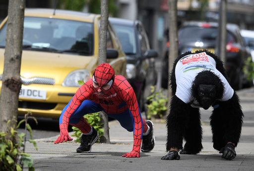 Charity event competitor, Tom Harrison, is joined by local a local resident and former world record holder for quickest Marathon time in fancy dress, as he continues his crawl in a gorilla outfit to raise money for the Gorilla Foundation