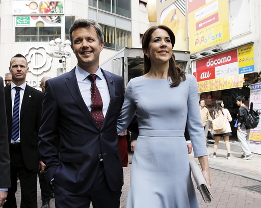 Denmark's Crown Prince Frederik and his wife Crown Princess Mary walk on a street at Shibuya shopping district in Tokyo