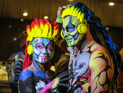 Models pose backstage during a body art festival in Almaty