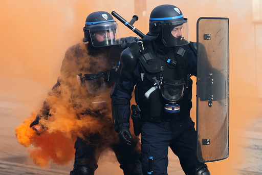 French CRS riot police face off with protestors during a demonstration against French government reforms in Nantes