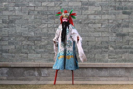 A performer wearing costumes walk on stilts before a show during a lantern fair at the beginning of Chinese Lunar New Year, in Xi'an