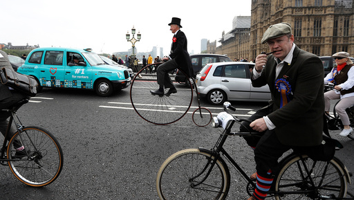 Participants in The Tweed Run cycle ride across Westminster Bridge in London