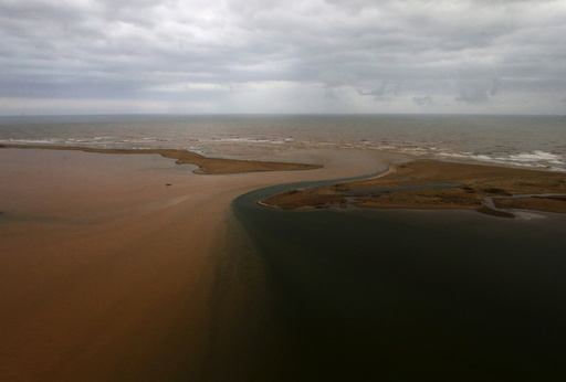 An aerial view of the mouth of Rio Doce (Doce River), which was flooded with mud after a dam owned by Vale SA and BHP Billiton Ltd burst, is seen as the river joins the sea on the coast of Espirito Santo, in Regencia Village, Brazil