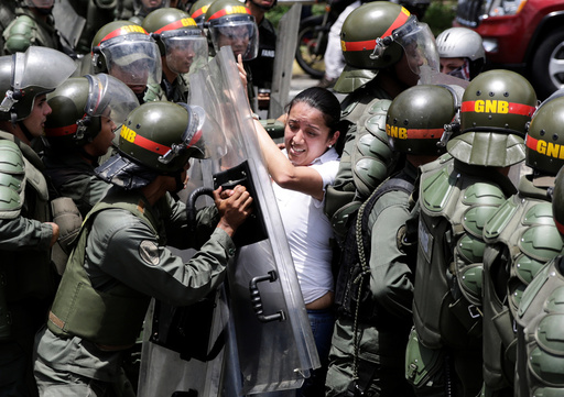 Arellano, deputy of the Venezuelan coalition of opposition parties (MUD), clashes with national guards during a rally against Venezuela's President Nicolas Maduro's government in Caracas
