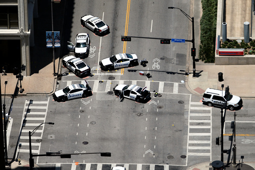 Law enforcement personnel investigate a mass shooting scene at El Centro Community College at the intersection of N Lamar St. and Main St. after an attack which killed and wounded Dallas police officers, in Dallas