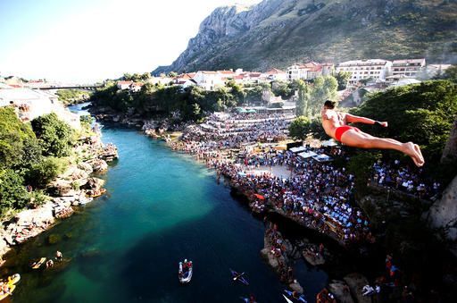 A man jumps from the Old Bridge during 450th traditional diving competition in Mostar