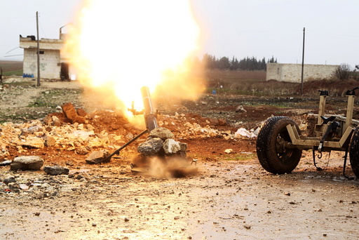 Free Syrian Army fighter fires a shell towards Islamic State fighters in the northern Aleppo countryside, Syria
