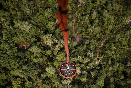 An Mi-17 helicopter carries water to be dumped on a burning forest at Ogan Komering Ulu area in Indonesia's south Sumatra province