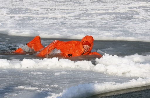 Britain's Prince Harry swims in icy water as he wears an immersion suit on the island of Spitsbergen, between the Norwegian mainland and the North Pole