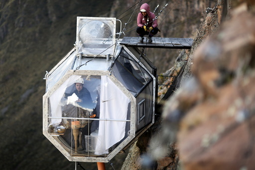 A guest cleans the inside of a sleeping pod at the Skylodge Adventure Suites in the Sacred Valley in Cuzco