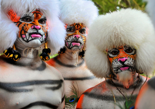 Men dressed as tigers wait to perform during celebrations to mark the Navratri festival, during which devotees worship the Hindu goddess Durga, in Mangaluru