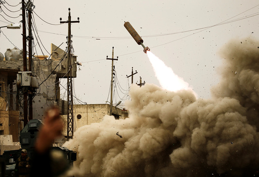 Iraqi rapid response members fire a missile against Islamic State militants during a battle with the militants in Mosul