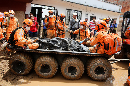 Rescue members recover a body in a house after flooding and mudslides caused by heavy rains leading several rivers to overflow, pushing sediment and rocks into buildings and roads, in Mocoa