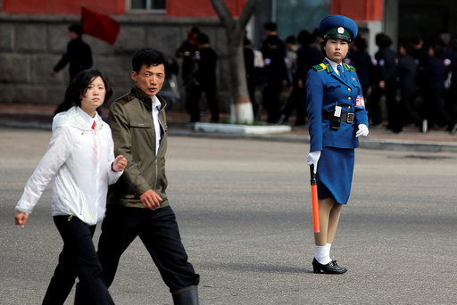 People cross the street in central Pyongyang, North Korea