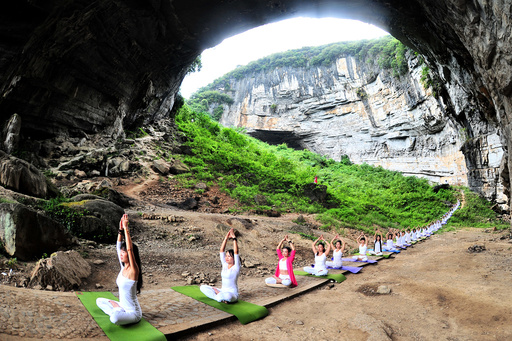 Yoga enthusiasts practice yoga at Yueyan Cave during session organised by yoga club in Daoxian