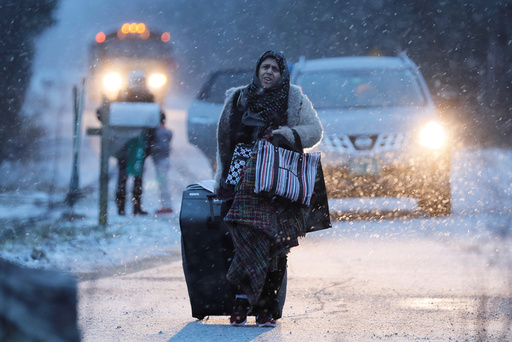 A woman walks towards the border to cross at the U.S.-Canada border after arriving in a taxi with a group that claimed to be from Syria into Hemmingford