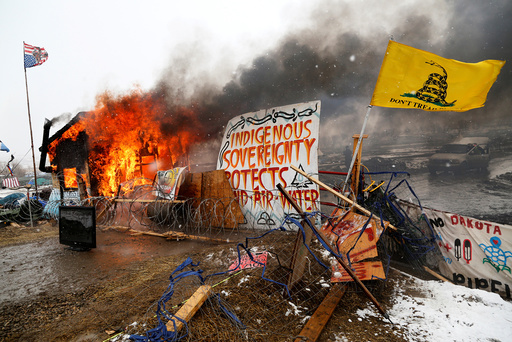A structure burns after being set alight by protesters preparing to evacuate the main opposition camp against the Dakota Access oil pipeline near Cannon Ball