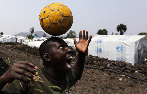 A Congolese boy displaced by recent fighting in North Kivu, juggles a ball near his makeshift shelter at the Mugunga III camp for internally displaced people near Goma