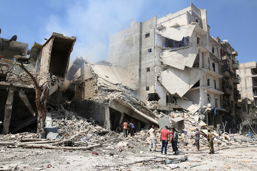 Men inspect a damaged site after double airstrikes on the rebel held Bab al-Nairab neighborhood of Aleppo