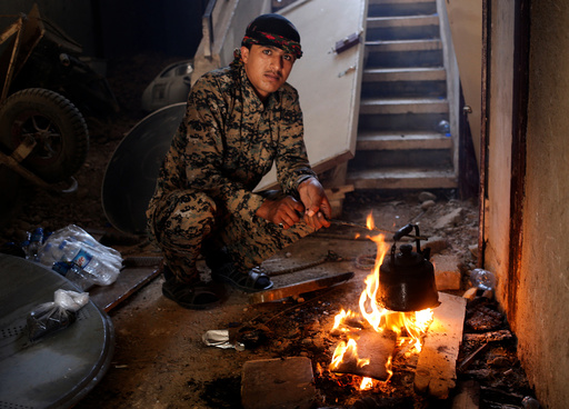 A Syrian Democratic Forces (SDF) fighter prepares tea in house in Raqqa
