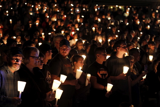 People take part in candlelight vigil following a mass shooting at Umpqua Community College in Roseburg Oregon