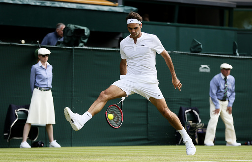 Roger Federer of Switzerland hits a shot through his legs during his match against Sam Querrey of the U.S.A. at the Wimbledon Tennis Championships in London
