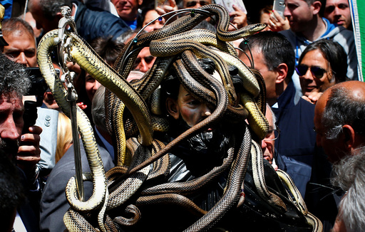 Snakes cover a wooden statue of Saint Domenico during a procession in Cocullo
