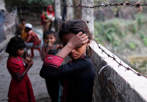 A Rohingya refugee girl wipes her eyes as she cries at Leda Unregistered Refugee Camp in Teknaf