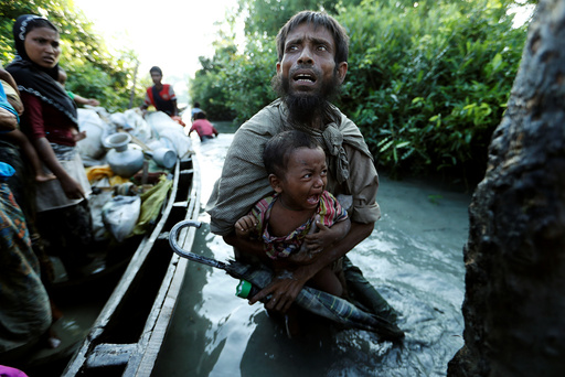Rohingya refugees arrive to the Bangladeshi side of the Naf river after crossing the border from Myanmar, in Palang Khali