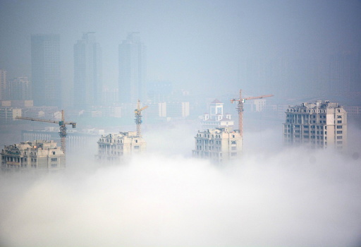 Buildings under construction are seen during a hazy day in Rizhao