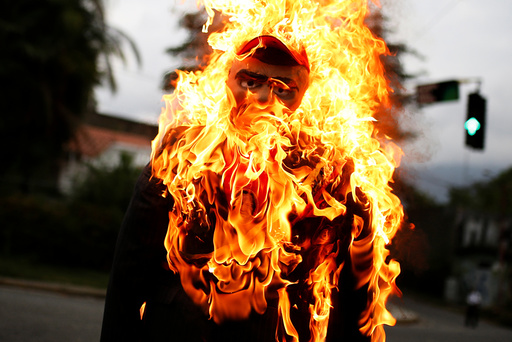 An effigy depicting Venezuela's President Nicolas Maduro is set alight during the traditional burning of Judas as part of Holy Week celebrations, at a street in Caracas