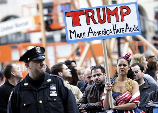 People take part in an anti-Donald Trump, pro-immigration protest outside the Plaza Hotel, where U.S. Republican presidential candidate Donald Trump spoke, in the Manhattan borough of New York
