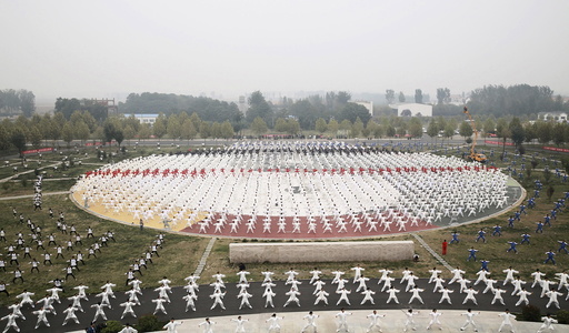 Participants practice Taichi on a square during a Guinness World Record attempt of the largest martial arts display, on a hazy day in Jiaozuo