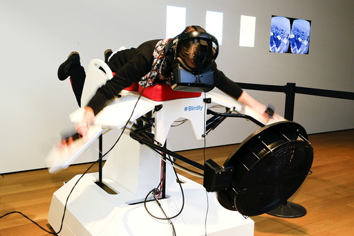 A visitor tries the flight simulator Birdly at the exhibition 