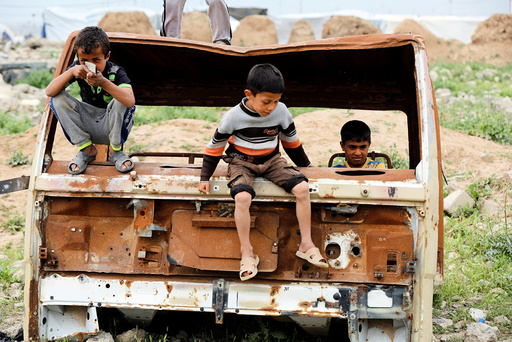 Displaced Iraqi children who fled their homes with their families play outside Hammam al-Alil camp south of Mosul