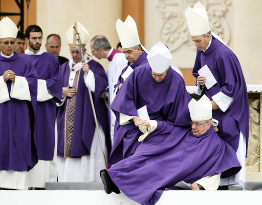 Bishop Emeritus Claudio Stagni receives help after fall down as Pope Francis leaves at the end of Holy Mass in Carpi
