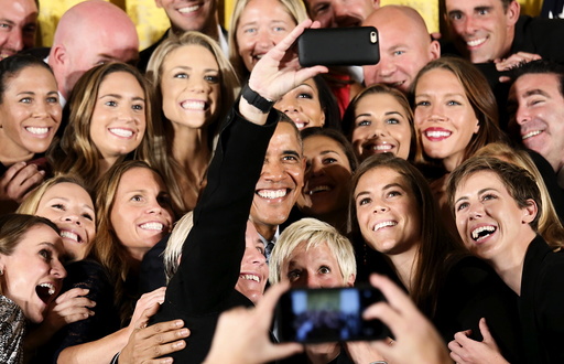 U.S. President Barack Obama poses for a selfie with US women's soccer team at the White House in Washington