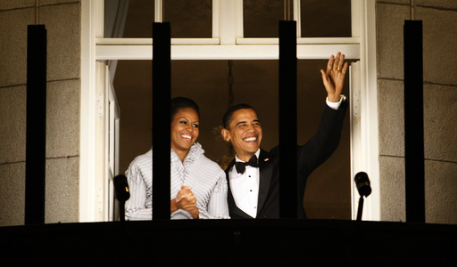 U.S. President Barack Obama and his wife Michelle wave from the balcony of the Grand Hotel in Oslo