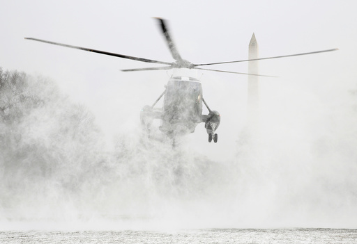 Marine One blows up a cloud of snow as it lands on the South Lawn of the White House in Washington.