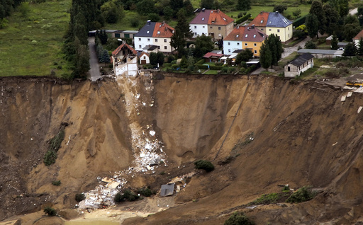 An aerial view shows the debris of a residential building and a destroyed road in the village of Nachterstedt