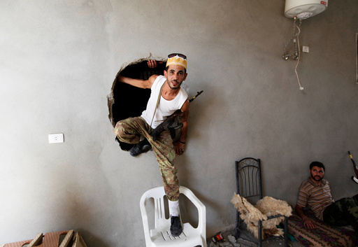 A fighter from Libyan forces allied with the U.N.-backed government climbs out of a hole during a fight with Islamic State in neighbourhood Number Three in Sirte