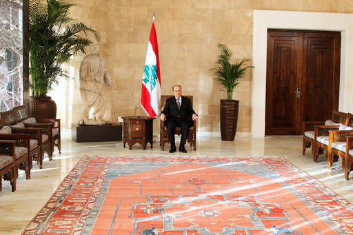 Aoun sits on the president's chair inside the presidential palace in Baabda