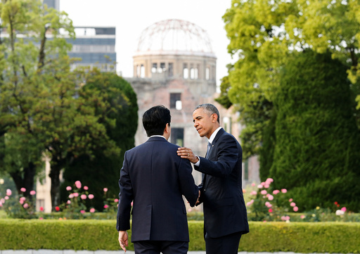 U.S. President Barack Obama puts arm around Japanese PM Abe after they laid wreaths in front of cenotaph as the atomic bomb dome is background at Hiroshima Peace Memorial Park in Hiroshima, Japan