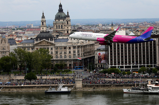 Wizz Air's Airbus A-321 flies along the Danibe river during an air show in Budapest