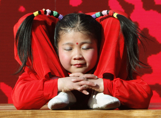 A young acrobat performs during a cultural show to celebrate Lunar New Year at a temple fair in Beijing
