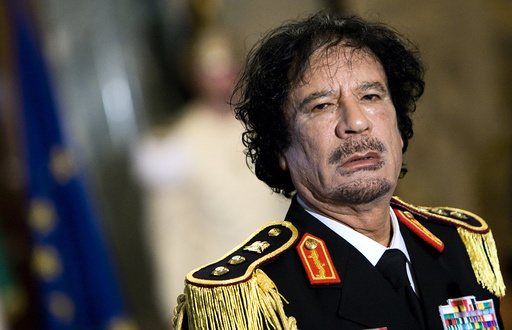 File photo of Libya's leader Gaddafi looking on during a news conference in Rome