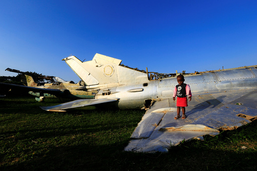 A child plays on the wreckages of war planes destroyed during an Israeli operation on the Entebbe international airport in 1976 to rescue hostages, at Aero beach, south of UgandaÃs capital Kampala